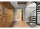 Hallway featuring a wooden closet, rug, and spiral staircase leading to a modern bathroom at 30 5Th Ne St # 1010, Atlanta, GA 30308