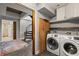 Laundry area adjacent to the bathroom and entryway to the stairway, equipped with modern appliances at 30 5Th Ne St # 1010, Atlanta, GA 30308
