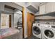 Laundry room with a modern washer and dryer and access to spiral staircase at 30 5Th Ne St # 1010, Atlanta, GA 30308