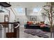 Bright living room featuring a black leather couch, area rug, and skylights for natural light at 30 5Th Ne St # 1010, Atlanta, GA 30308