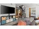 Open-concept living area featuring a spiral staircase, entertainment center and comfortable leather sofa at 30 5Th Ne St # 1010, Atlanta, GA 30308