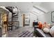 Bright living room featuring a black leather couch, area rug, skylights, and spiral staircase at 30 5Th Ne St # 1010, Atlanta, GA 30308