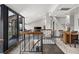Stylish living area showcasing a modern staircase, a dining area, and a balcony with city views at 30 5Th Ne St # 1010, Atlanta, GA 30308
