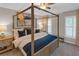 Stylish bedroom features a four-poster bed, accent art, and a bright window at 3123 Wolf Club Dr. Sw, Atlanta, GA 30349