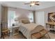 Cozy bedroom featuring neutral tones, a ceiling fan, plantation shutters, and plush carpeting at 3123 Wolf Club Dr. Sw, Atlanta, GA 30349