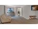 Relaxing bedroom with a comfy chair, dresser, TV, and neutral tones at 3123 Wolf Club Dr. Sw, Atlanta, GA 30349