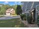 Manicured lawn with stone features highlights this home near a similar style brick two-story home at 3123 Wolf Club Dr. Sw, Atlanta, GA 30349