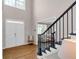 Inviting foyer with hardwood floors, a staircase, and a view into the adjacent living space at 3123 Wolf Club Dr. Sw, Atlanta, GA 30349