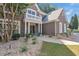 Elegant brick home with a covered entryway, white columns, and manicured landscaping creating inviting curb appeal at 3123 Wolf Club Dr. Sw, Atlanta, GA 30349