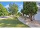 Landscaped front yard features mature trees, manicured lawn, and a welcoming sidewalk, perfect for curb appeal at 3123 Wolf Club Dr. Sw, Atlanta, GA 30349