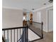 Upstairs hallway with black railings, carpet flooring and access to multiple rooms at 3123 Wolf Club Dr. Sw, Atlanta, GA 30349