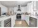 Modern kitchen featuring white cabinets, stainless steel appliances, and a spacious center island at 3123 Wolf Club Dr. Sw, Atlanta, GA 30349
