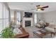 Inviting living room with a fireplace, plantation shutters, ceiling fan, and comfortable seating at 3123 Wolf Club Dr. Sw, Atlanta, GA 30349