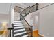 Elegant staircase showcasing dark wood railings and white risers leading to the second floor at 3123 Wolf Club Dr. Sw, Atlanta, GA 30349