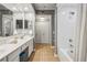 Bathroom featuring a shower with a white tile surround, and double sink vanity at 3777 Peachtree Ne Rd # 1216, Atlanta, GA 30319