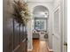 Welcoming entryway with hardwood floors, a decorative wreath, and an arched doorway to living area at 3777 Peachtree Ne Rd # 1216, Atlanta, GA 30319