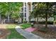 Apartment building with greenery, a small charcoal grill and a bench nearby at 3777 Peachtree Ne Rd # 1216, Atlanta, GA 30319