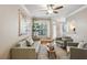 Cozy living room featuring hardwood floors, neutral paint, ceiling fan, and large window with blinds at 3777 Peachtree Ne Rd # 1216, Atlanta, GA 30319