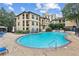 Community pool with lounge chairs and a waterfall feature at 3777 Peachtree Ne Rd # 1216, Atlanta, GA 30319