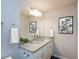 This sleek bathroom is completed with double sinks, light granite countertops, and modern artwork at 45 Chimney Ridge Ln, Covington, GA 30014