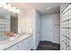 Well-lit bathroom featuring double sinks, granite countertops, and a shower-tub combo with a curtain at 45 Chimney Ridge Ln, Covington, GA 30014