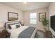 This primary bedroom is complete with stylish décor, soft natural light, and comfortable sleeping quarters at 45 Chimney Ridge Ln, Covington, GA 30014