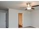 Neutral bedroom with standard ceiling fan, closet and entry to adjoining bathroom at 45 Chimney Ridge Ln, Covington, GA 30014