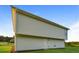 View of the home's durable siding, level yard, and a functional backdoor for easy access at 45 Chimney Ridge Ln, Covington, GA 30014