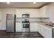 Well-equipped kitchen featuring stainless steel appliances, granite countertops, and ample cabinet space at 45 Chimney Ridge Ln, Covington, GA 30014