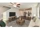 Open-concept living room with hardwood floors, a modern television, comfortable seating, and a view into the kitchen at 45 Chimney Ridge Ln, Covington, GA 30014