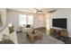 Cozy living room with a ceiling fan, neutral color scheme, comfortable seating, and a modern television at 45 Chimney Ridge Ln, Covington, GA 30014