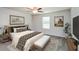 Serene main bedroom with a comfortable bed, neutral decor, and ample natural light from the bright window at 45 Chimney Ridge Ln, Covington, GA 30014