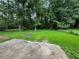 Spacious backyard featuring lush greenery, mature trees, and a rustic fire pit area, perfect for outdoor activities at 2014 Brannen Se Rd, Atlanta, GA 30316