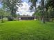 Picturesque backyard showcasing lush greenery and mature trees surrounding a charming brick home with outdoor patio space at 2014 Brannen Se Rd, Atlanta, GA 30316