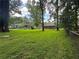 Large backyard with mature trees, offering ample space for recreation and privacy, near a charming neighboring house at 2014 Brannen Se Rd, Atlanta, GA 30316