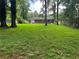 Expansive backyard with mature trees and direct access to the brick home, ideal for Gathering gatherings and outdoor living at 2014 Brannen Se Rd, Atlanta, GA 30316