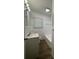 Clean bathroom with white tiled walls, modern fixtures, and a shower-tub combination at 2014 Brannen Se Rd, Atlanta, GA 30316