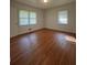 Cozy bedroom with hardwood floors, large windows offering natural light, and a neutral color palette at 2014 Brannen Se Rd, Atlanta, GA 30316