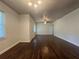 Spacious living room featuring wood floors, white walls, and lots of natural light from the windows at 2014 Brannen Se Rd, Atlanta, GA 30316