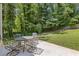 Enjoy outdoor dining on this patio set against a backdrop of lush greenery at 231 Cross Gate Dr, Marietta, GA 30068