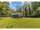 Sprawling backyard featuring a screened porch and wooden deck, perfect for outdoor entertaining at 231 Cross Gate Dr, Marietta, GA 30068