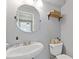 This bathroom features a stylish round mirror, open shelf, and grey paint at 231 Cross Gate Dr, Marietta, GA 30068