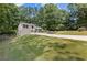 Inviting home exterior with mature trees, a long driveway, and a well-kept lawn at 231 Cross Gate Dr, Marietta, GA 30068
