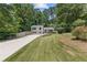 Enjoy the wide front yard, beautiful garden beds, and convenient driveway at 231 Cross Gate Dr, Marietta, GA 30068