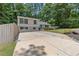 Charming two-story home with a spacious driveway and well-maintained lawn surrounded by lush greenery at 231 Cross Gate Dr, Marietta, GA 30068