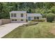 Charming home featuring a well-maintained yard, inviting blue door, and lush landscaping at 231 Cross Gate Dr, Marietta, GA 30068