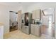 Bright kitchen with stainless steel appliances, light-colored cabinets, and tile flooring at 231 Cross Gate Dr, Marietta, GA 30068