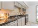 Modern kitchen with granite countertops, stainless steel appliances, and neutral-toned cabinetry at 231 Cross Gate Dr, Marietta, GA 30068