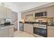 Updated kitchen featuring stainless steel appliances, granite counters, and tan colored cabinets at 231 Cross Gate Dr, Marietta, GA 30068