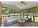The screened in porch has a ceiling fan and overlooks the back yard at 231 Cross Gate Dr, Marietta, GA 30068